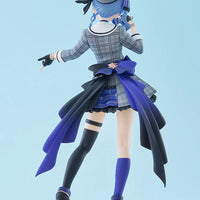 Figurine of a character in a plaid outfit with a blue ribbon against a light blue background